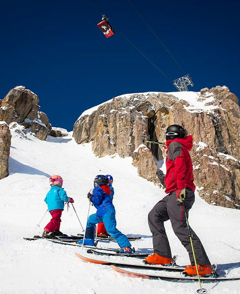 MSS intrcutor with kids looking up at Corbet's Couloir