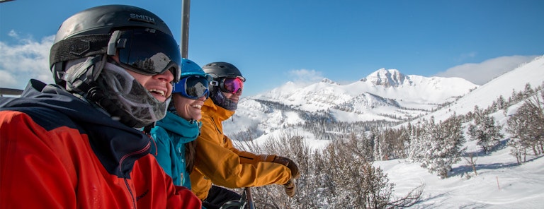 Employees smiling on a chairlift