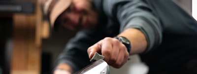 Employee tuning a pair of skis