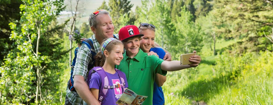 family taking a selfie on a hike