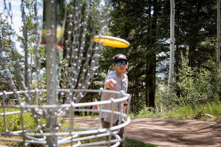 Thowing a disc into the basket