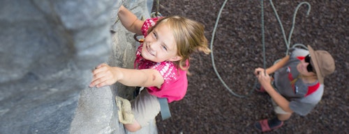 Girl having a blast on the climbing wall