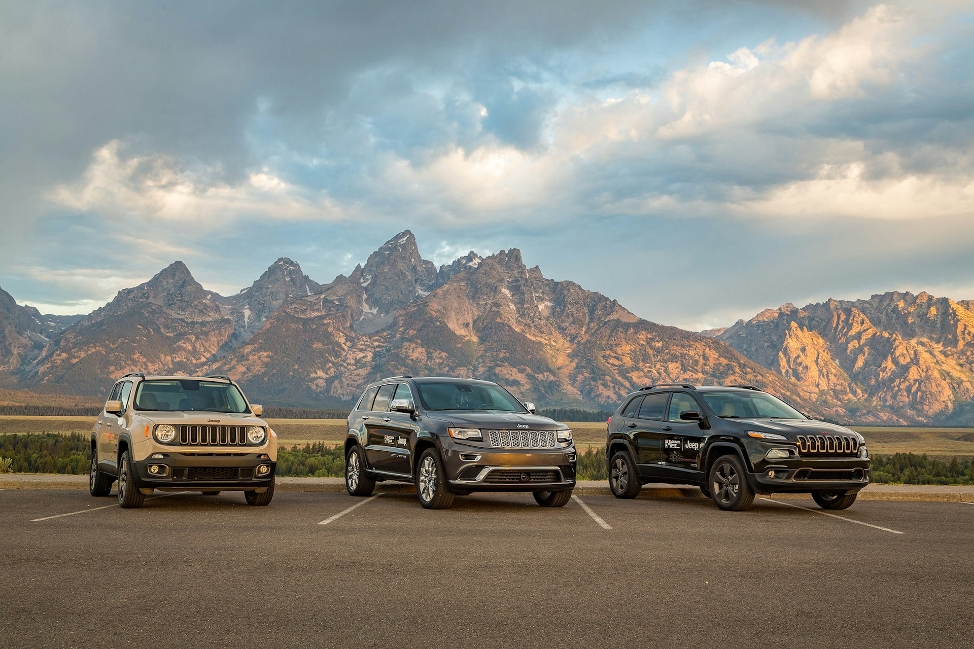 Three Jeeps lined up in front of the Tetons