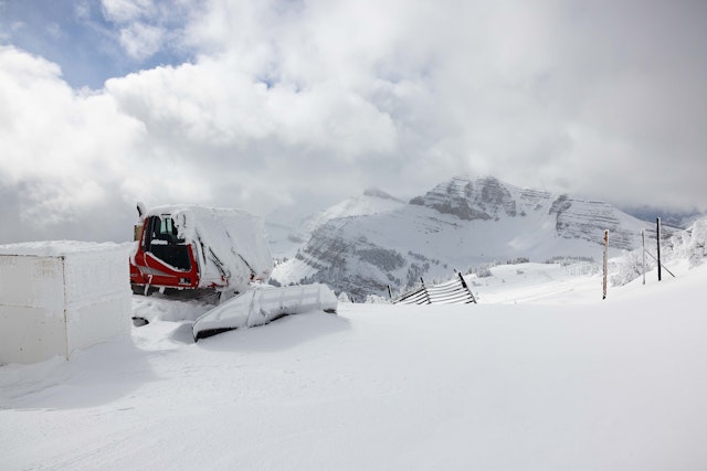 Snow covered snow cat at the top of the mountain