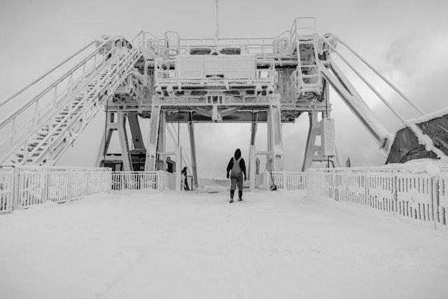 Tram operator walking towards the snowy Tram dock