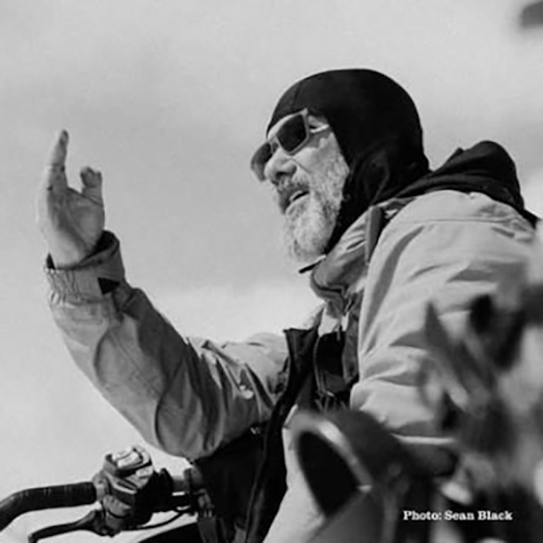 Black and white shot of Bryan Iguchi on a snowmobile