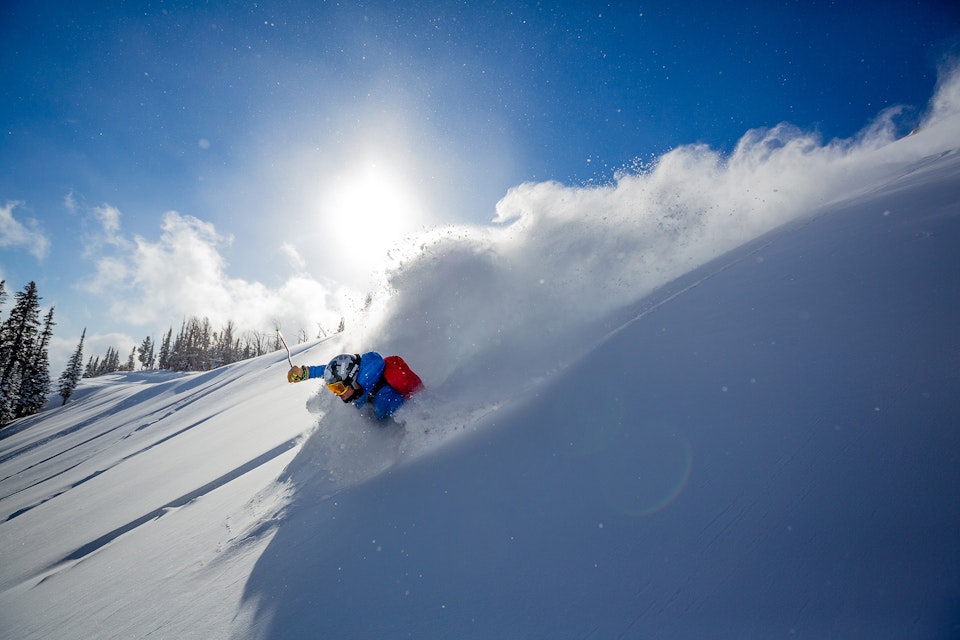 Skier shredding through waist deep pow