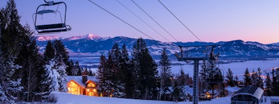 Large log lodge lit up at night