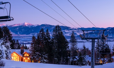 Large log lodge lit up at night