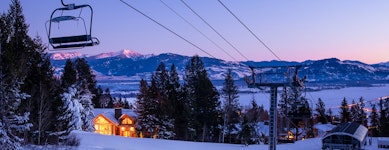 Large log lodge lit up at night