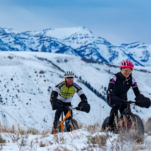 Two people out on a scenic fat bike tour in the winter