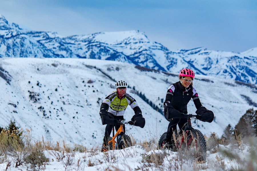 Two people out on a scenic fat bike tour in the winter