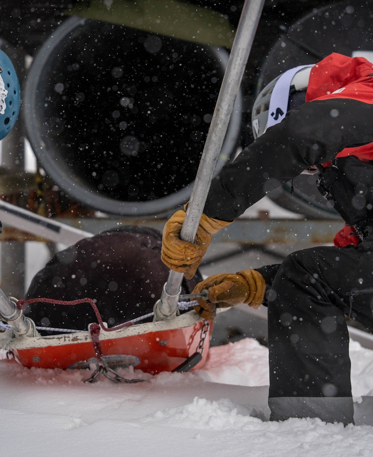 Patrollers securing a toboggan.