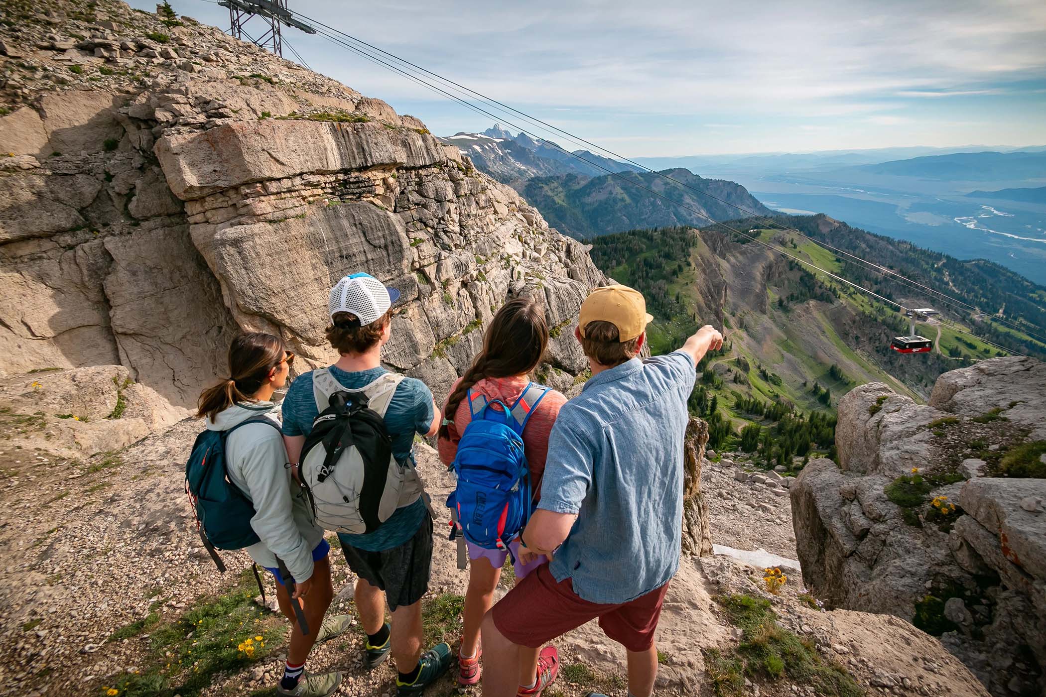 Hikers looking into the distance with Tram in background