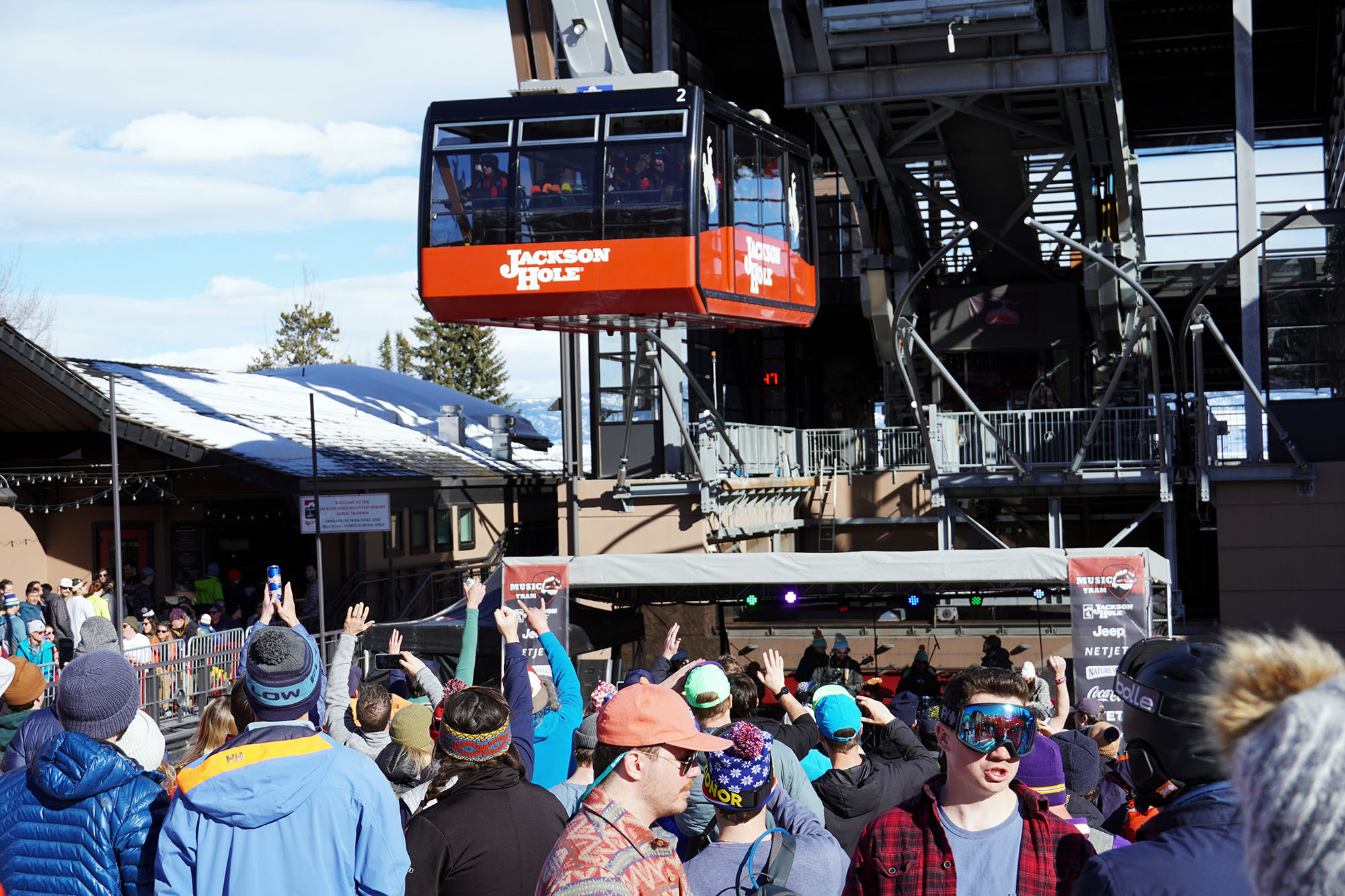 crowd at music under the tram with the tram flying overhead