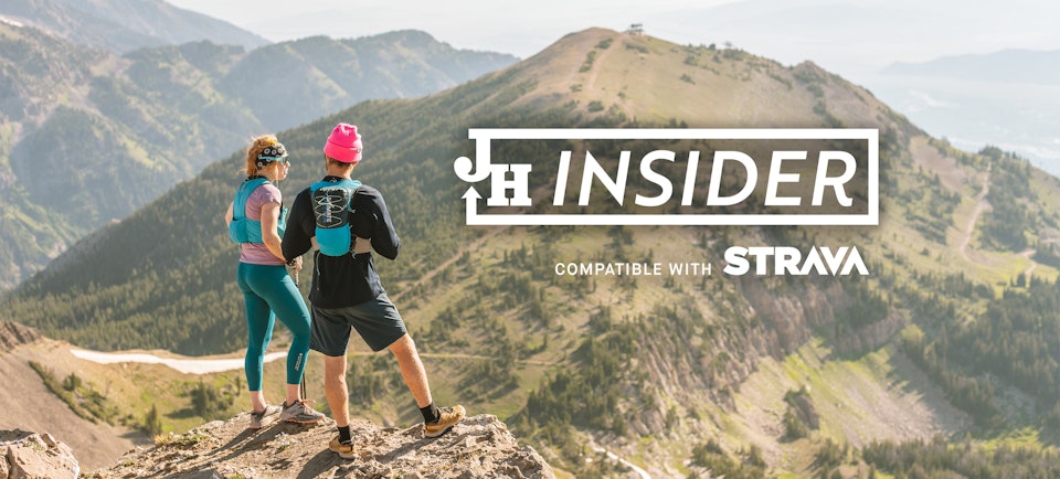 Two people hiking with JH Insider compatible with Strava logo overlaid