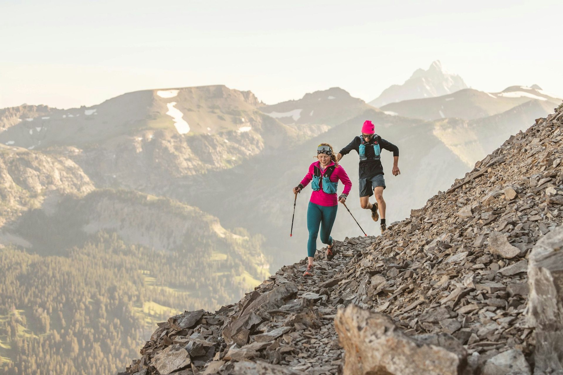 Man and woman trail running on Cody Peak