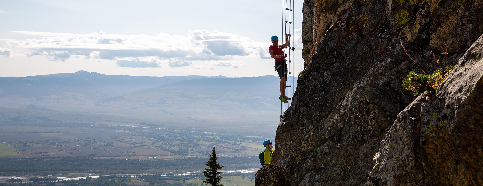 people climbing up ladder in Via Ferrata