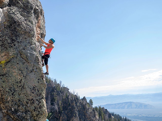Woman climbing on the Via Ferrata