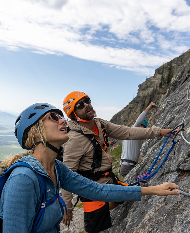 Man and woman looking up wall on Via Ferrata