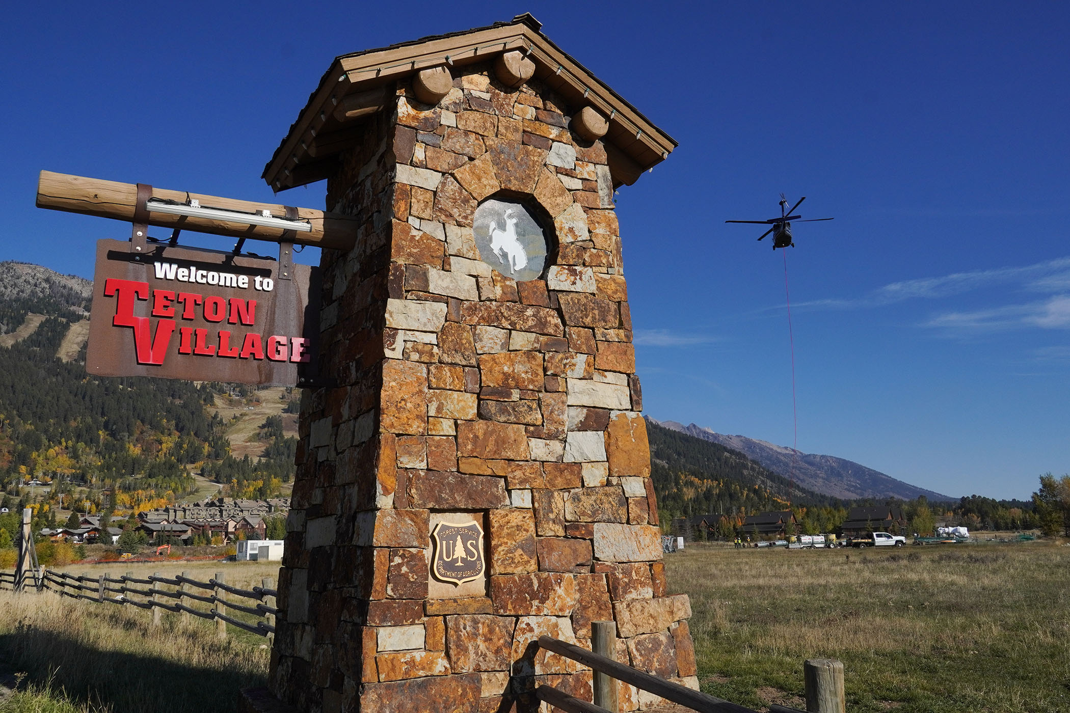 Helicopter next to the Teton Village sign