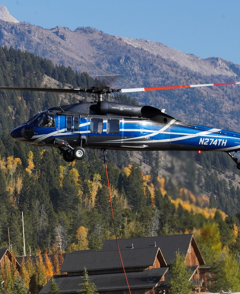 Helicopter getting ready to carry parts to mountain