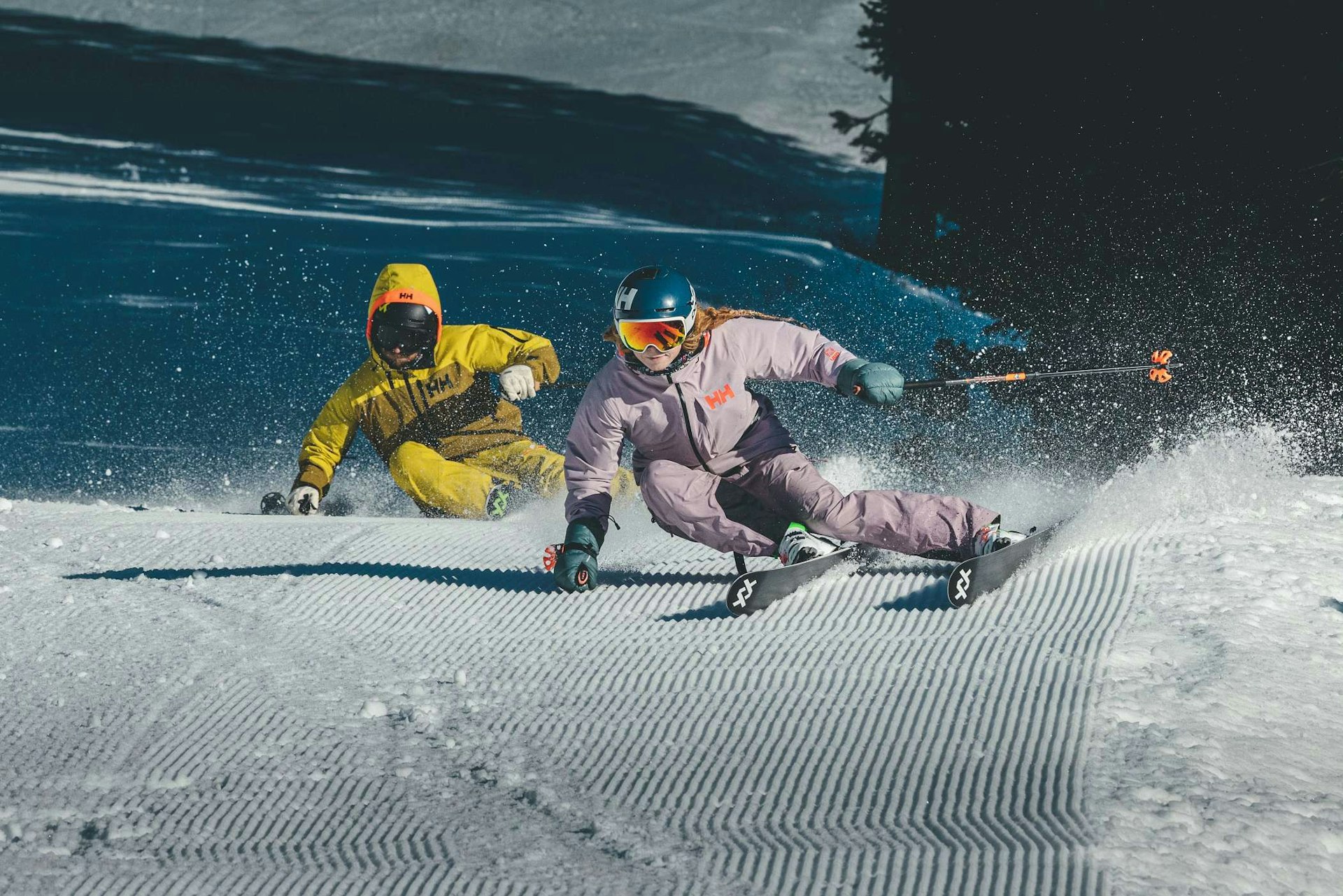 Madison Rose Ostergren skiing groomed run with another skier