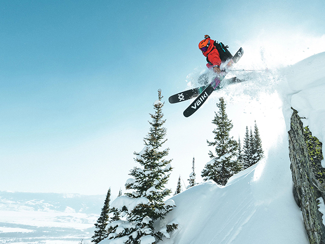 Person skiing off a cliff