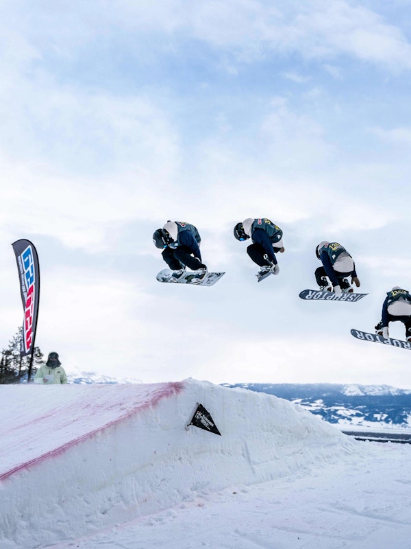 progression of a snowboarder doing a spin off a jump