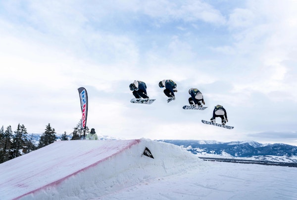 progression of a snowboarder doing a spin off a jump