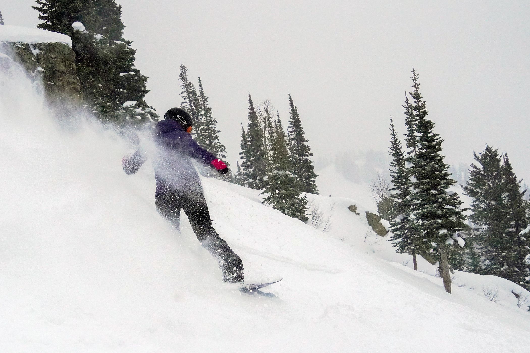 Snowboarder riding in powder