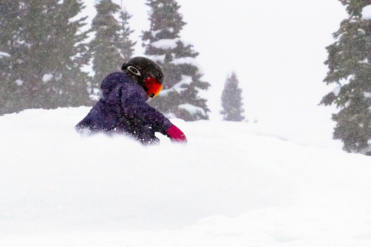 Snowboarder riding in powder