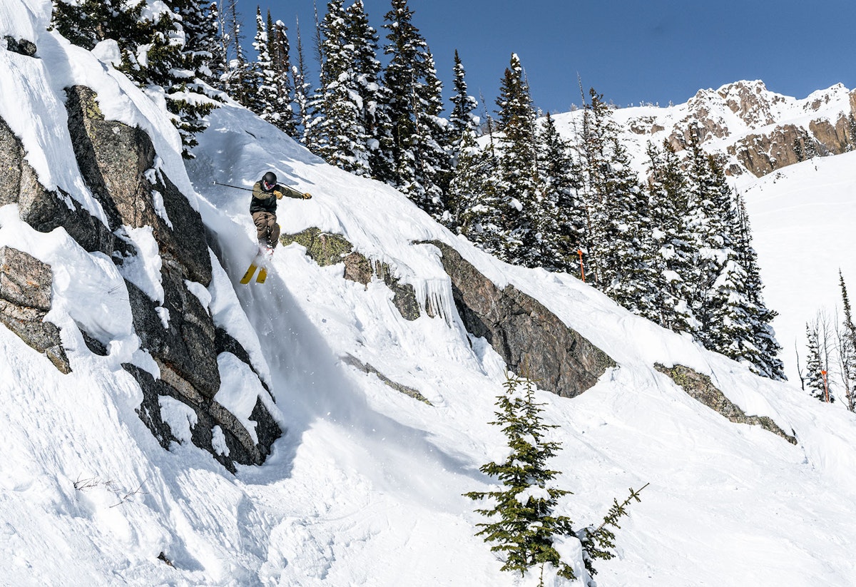 Skier jumping off a cliff