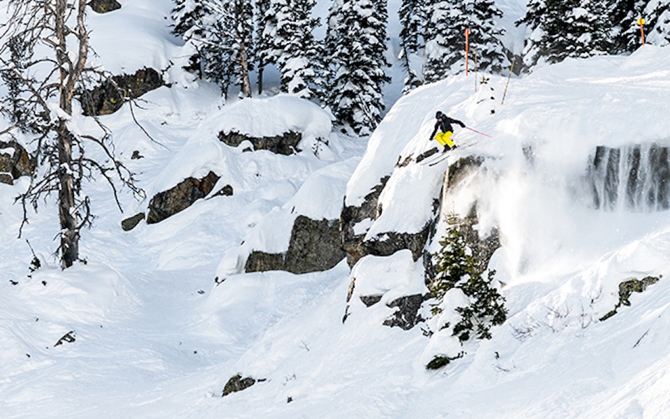 Skier jumping off a cliff