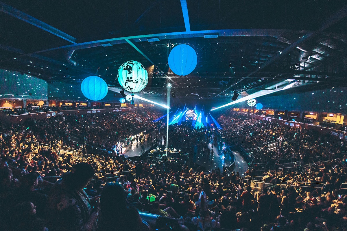 An arena of people watching The Librarian perform