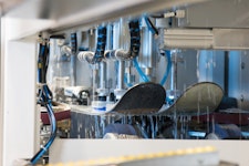 Skis being waxed by a machine