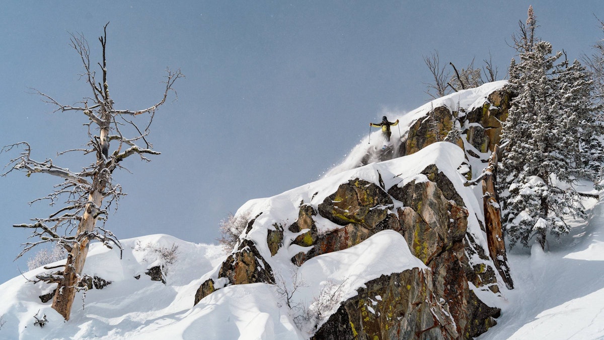 Skier getting air off a large cliff