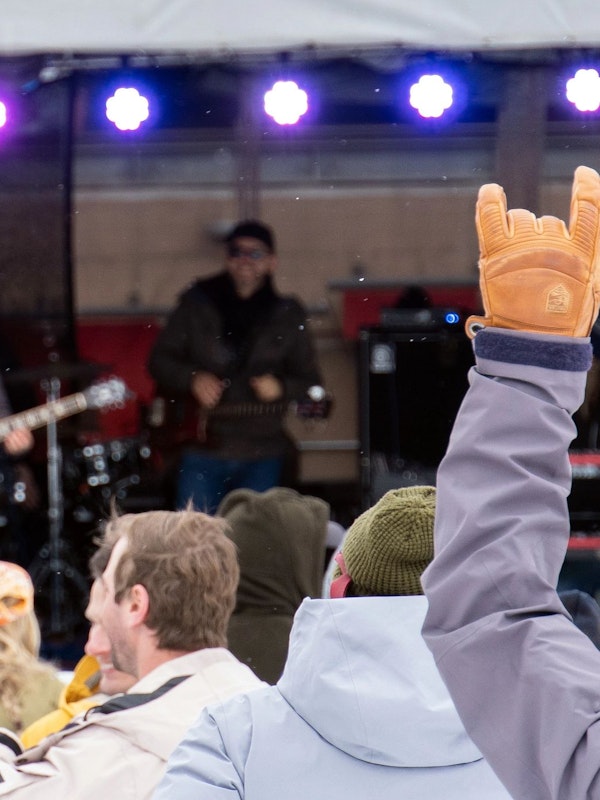 Person giving the "Rock On" hand signal during Road to Rendezvous performance