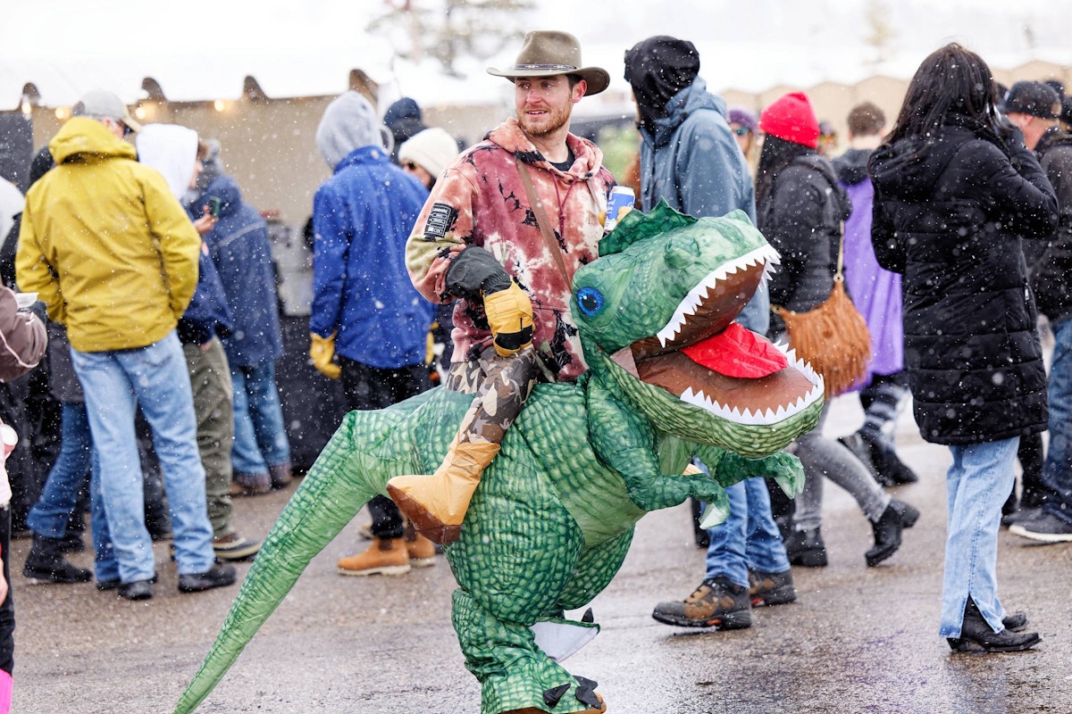 Man in a costume of him riding a dinosaur at Rendezvous Spring Festival