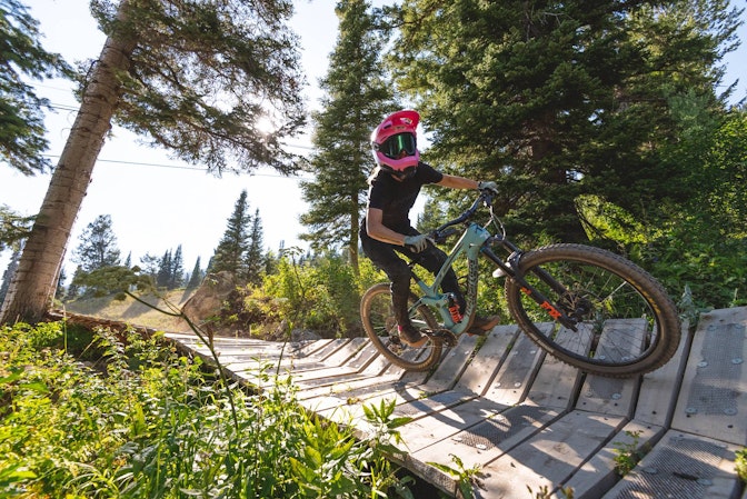 Riding a wooden berm in the bike park