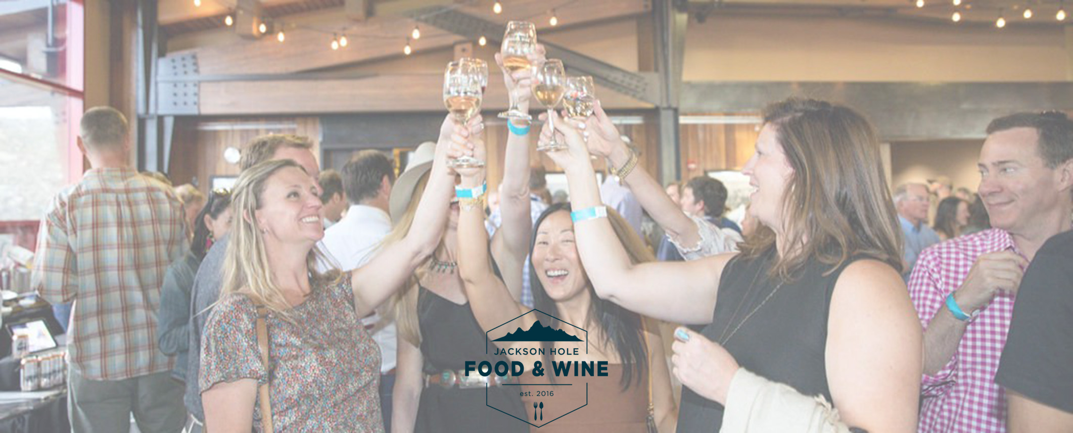 People cheersing wine with JH Food & Wine logo