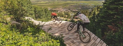 Biking on a wooden berm in the bike park