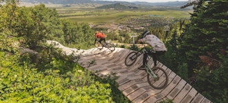 Biking on a wooden berm in the bike park