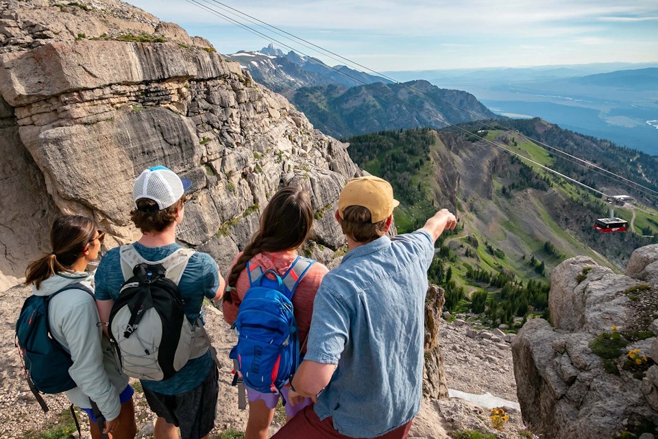 Four hikers looking at the Aerial Tram