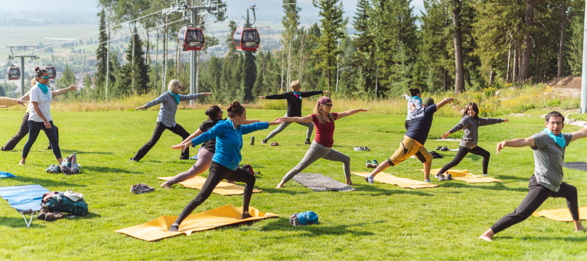 People doing yoga outside with the gondola in the background