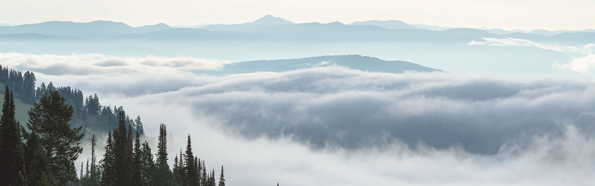 View above the clouds with mountains in the background