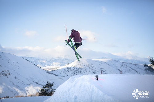 Skier going off a jump at Snow King. Credit: New Thought Media