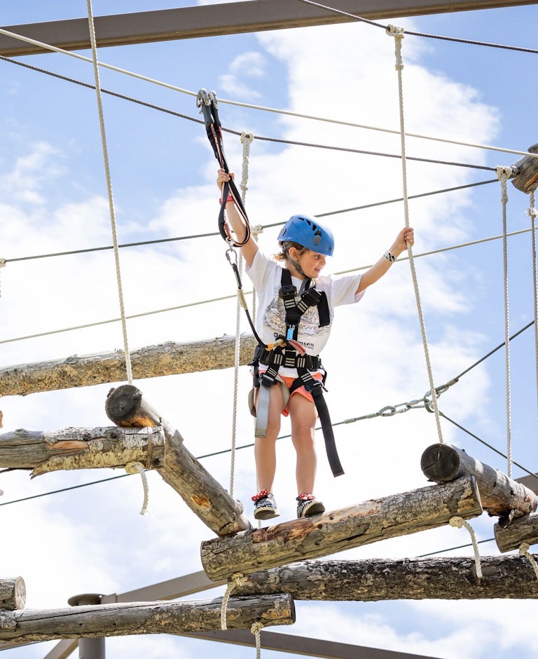 Two girls on the aerial ropes course