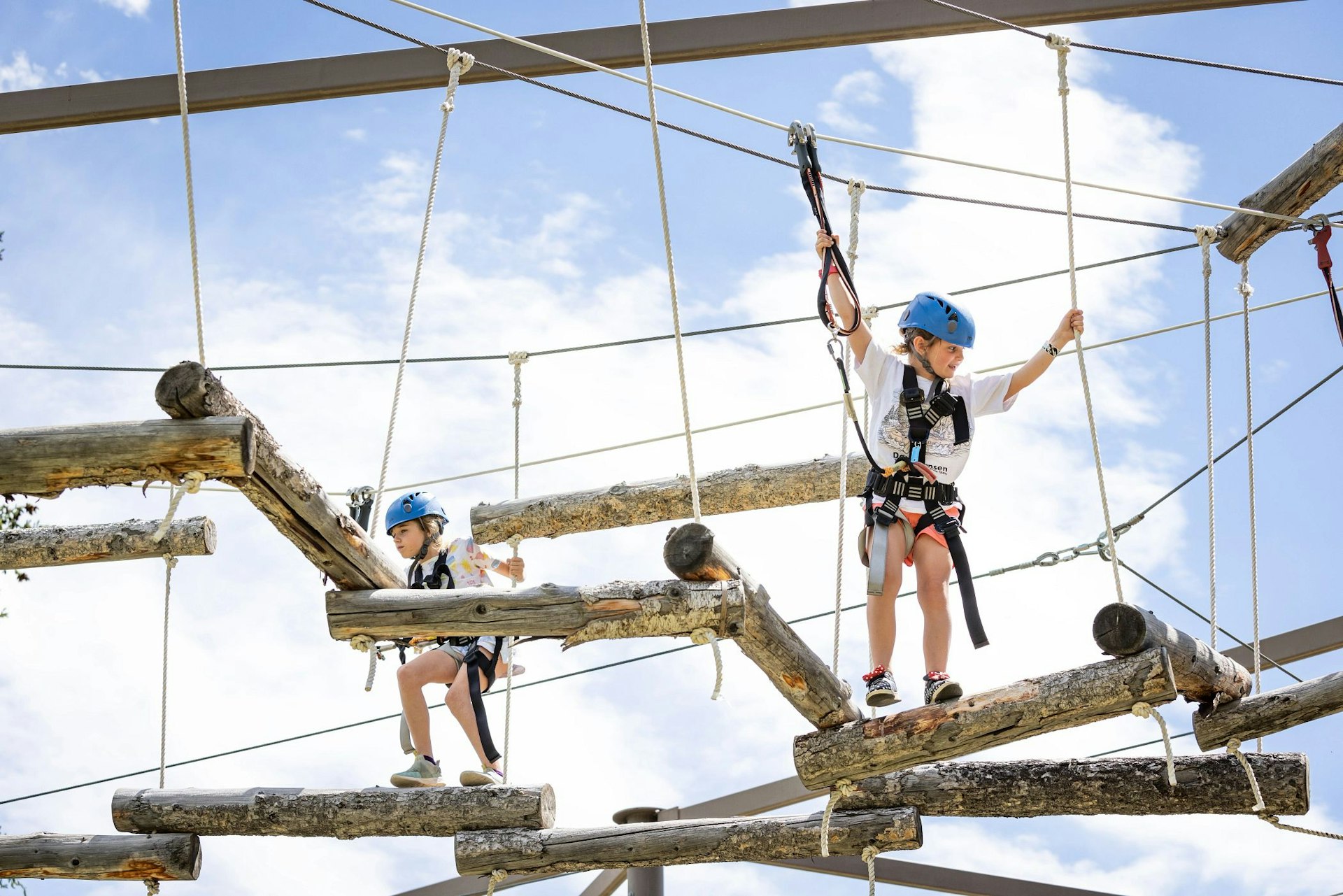Two girls on the aerial ropes course