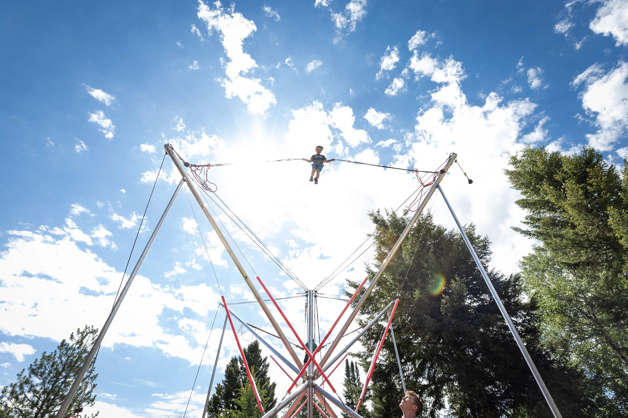a child jumping high on the bungee trampoline